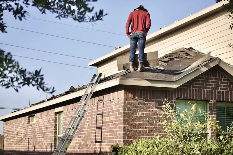 Professional roofer working on a residential roof in Towne Square Villas Condominiums